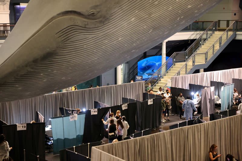 FILE PHOTO: People receive COVID-19 vaccines at the American Museum of Natural History in New York