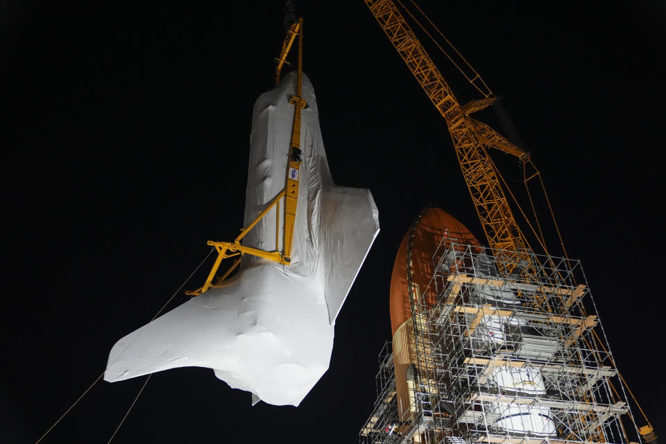 Space Shuttle Endeavour is lifted into the site of the future Samuel Oschin Air and Space Center on Tuesday, Jan. 30, 2024, in Los Angeles. (AP Photo/Ashley Landis)