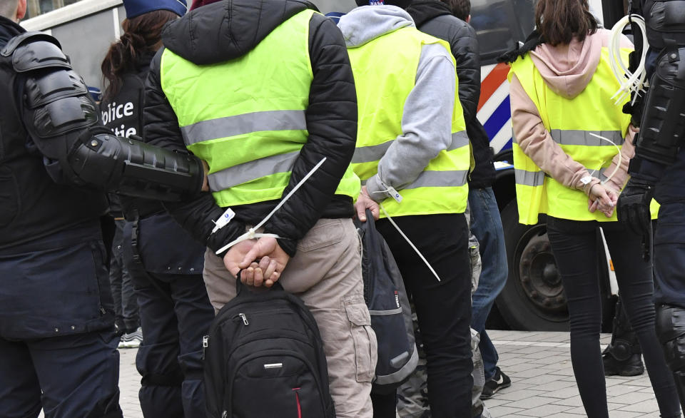 Police detain protestors in the European Quarter during a demonstration in Brussels, Saturday, Dec. 8, 2018. Hundreds of police officers are being mobilized in Brussels Saturday, where yellow vest protesters last week clashed with police and torched two police vehicles. More than 70 people were detained. (AP Photo/Geert Vanden Wijngaert)