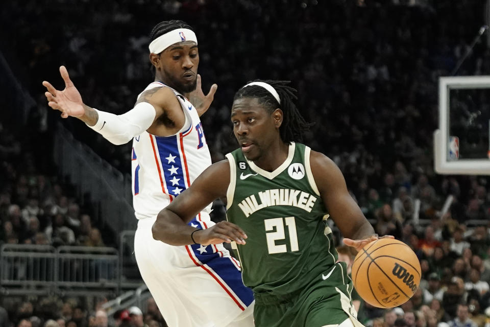 Milwaukee Bucks' Jrue Holiday (21) drives to the basket against Philadelphia 76ers' Jalen McDaniels during the second half of an NBA basketball game Saturday, March 4, 2023, in Milwaukee. (AP Photo/Aaron Gash)