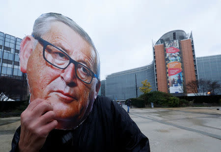 A protestors wearing a mask depicting European Commission President Jean-Claude Juncker demonstrates against a five-year extension of the license for weed-killer glyphosate that the European Commission will propose on Monday, in Brussels, Belgium, November 27, 2017. REUTERS/Yves Herman