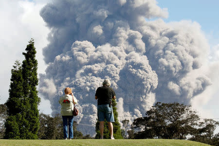 FILE PHOTO: People watch ash erupt from the Halemaumau Crater near the community of Volcano during ongoing eruptions of the Kilauea Volcano in Hawaii, U.S., May 19, 2018. REUTERS/Terray Sylvester/File Photo