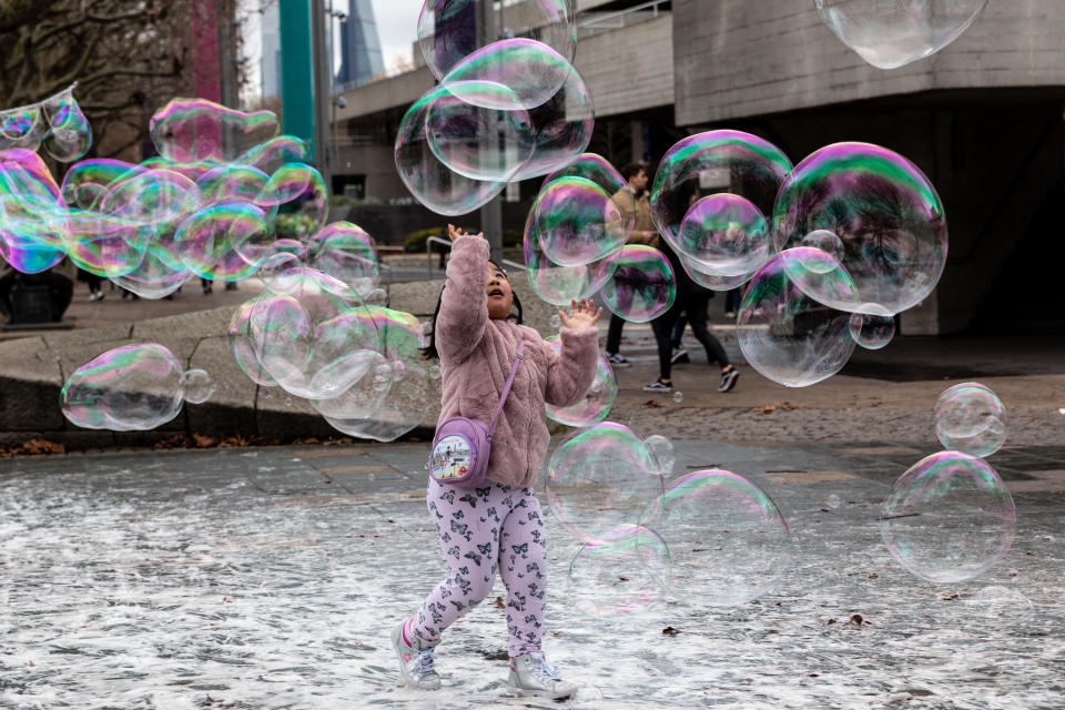 An Asian girl seen playing with soap bubbles in Southbank district of London England on December 1, 2019. (Photo by Dominika Zarzycka/NurPhoto via Getty Images)