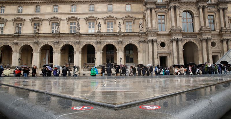 People line up at the Louvre Museum as the staff closed the museum during a staff meeting about the coronavirus outbreak, in Paris