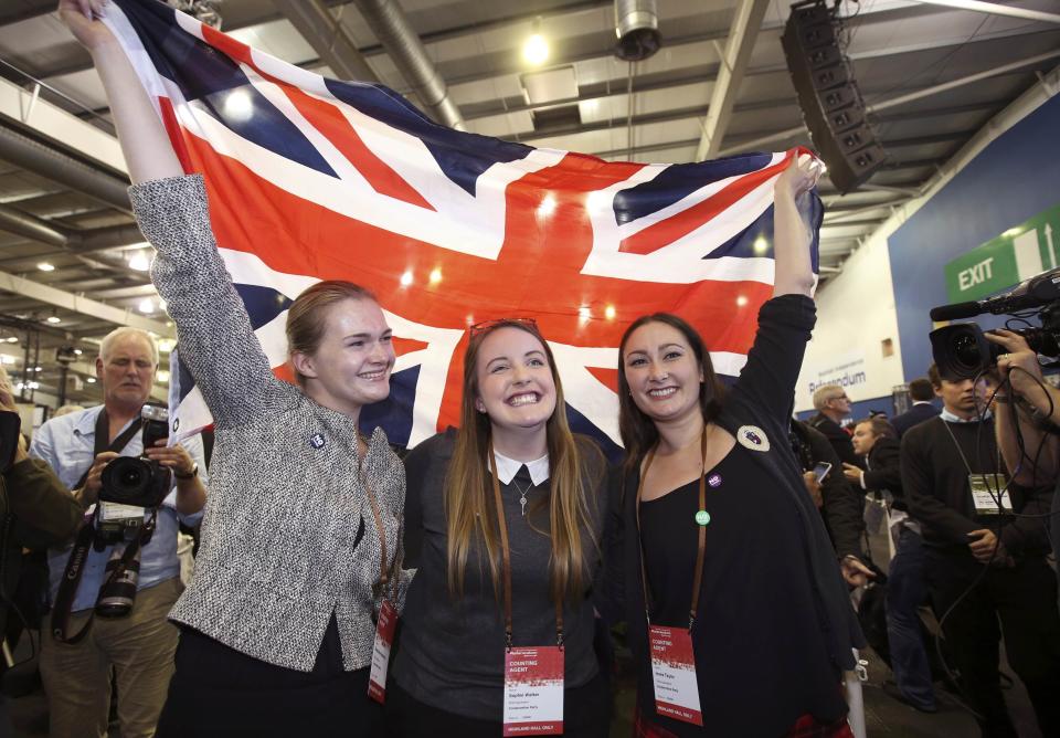 Supporters from the "No" Campaign celebrate as they hold up a Union flag, in Edinburgh, Scotland