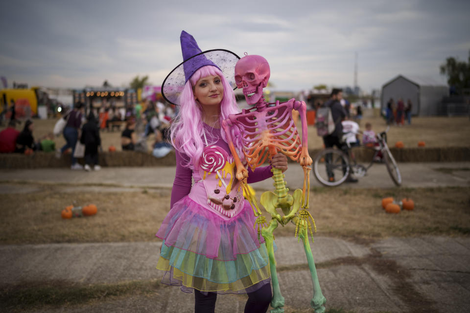 A woman poses for a photograph at the West Side Hallo Fest, a Halloween festival in Bucharest, Romania, Friday, Oct. 27, 2023. Tens of thousands streamed last weekend to Bucharest's Angels' Island peninsula for what was the biggest Halloween festival in the Eastern European nation since the fall of Communism. (AP Photo/Vadim Ghirda)