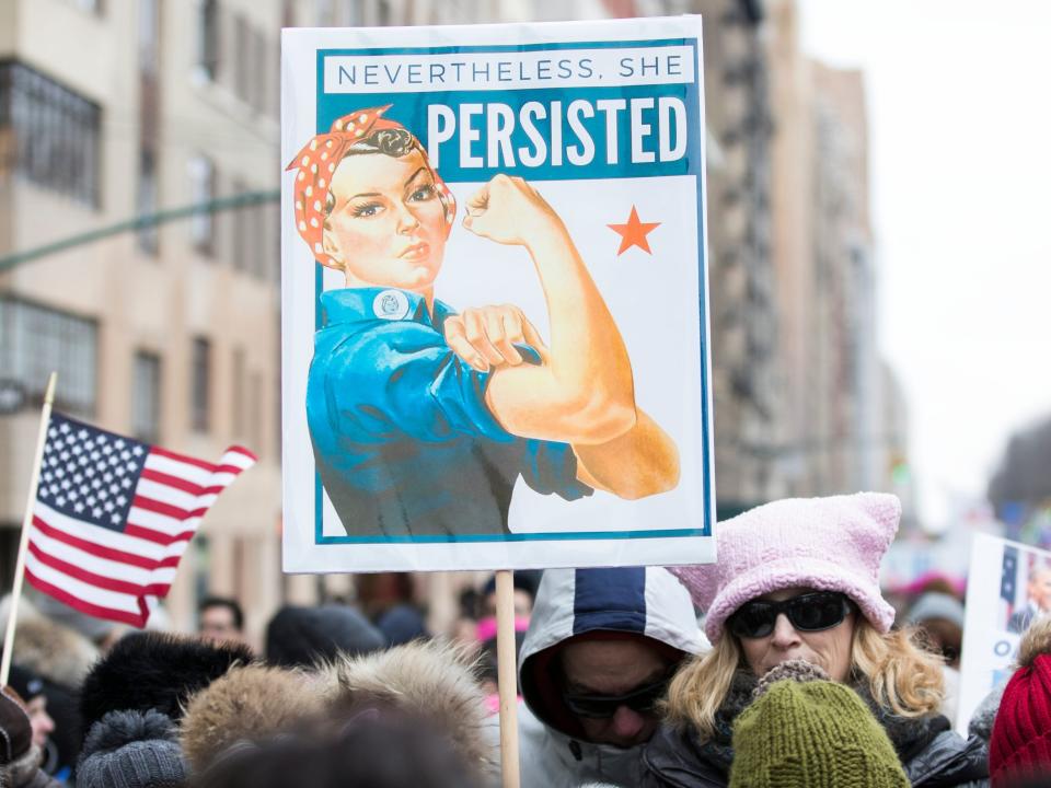 A group of marchers with signs that say "Nevertheless. She Persisted" with Rosie the Riveter during the Woman's March in New York City on January 19, 2019