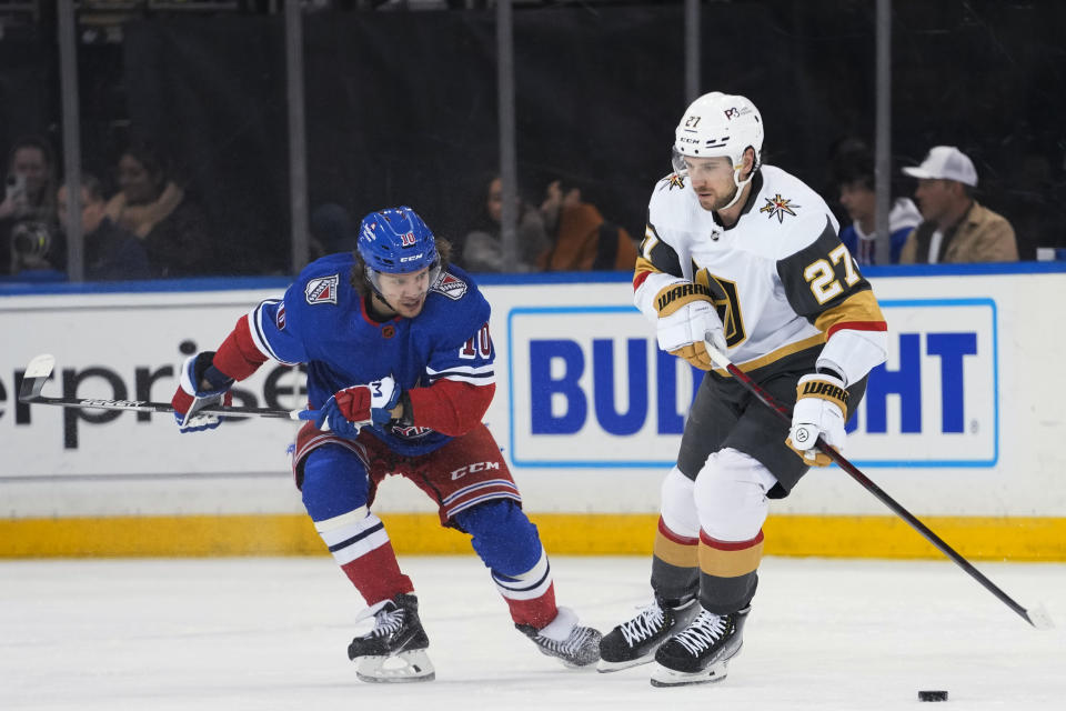 New York Rangers left wing Artemi Panarin (10) defends against Vegas Golden Knights defenseman Shea Theodore (27) during the first period of an NHL hockey game, Friday, Jan. 27, 2023, at Madison Square Garden in New York. (AP Photo/Mary Altaffer)