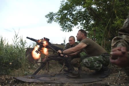 Members of the Ukrainian armed forces fire a grenade launcher, in response to what servicemen said were shots fired from the positions of fighters of the separatist self-proclaimed Donetsk People's Republic, in the town of Avdiivka in Donetsk region, Ukraine, June 18, 2015. REUTERS/Maksim Levin