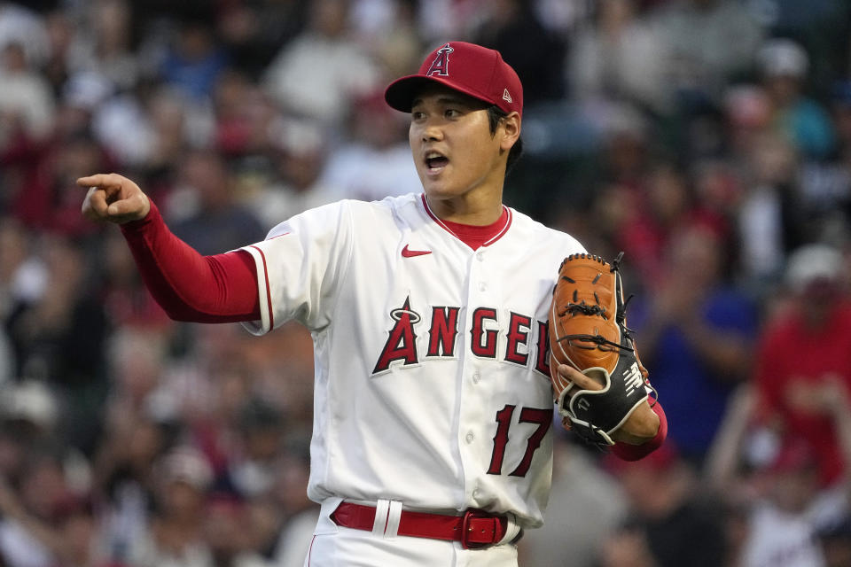 Los Angeles Angels starting pitcher Shohei Ohtani gestures to a teammate after Miami Marlins' Xavier Edwards grounded into a double play to end the top of the second inning of a baseball game Saturday, May 27, 2023, in Anaheim, Calif. (AP Photo/Mark J. Terrill)