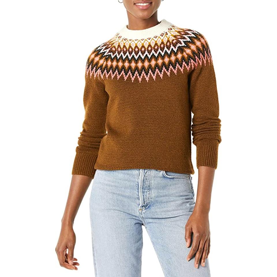 woman wearing brown and multicolor sweater and jeans