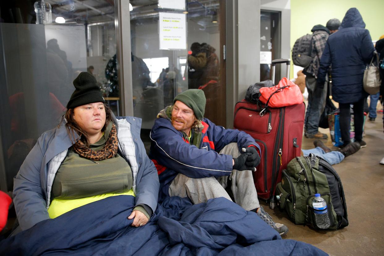 Ashley Wise, left, and Jeremy Cunningham sit Thursday inside the day shelter at the Homeless Alliance in Oklahoma City during a winter storm.