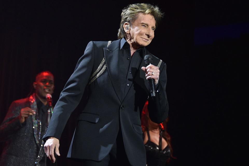 <p>David Crotty/Getty</p> Barry Manilow performs in Palm Springs in March 2024