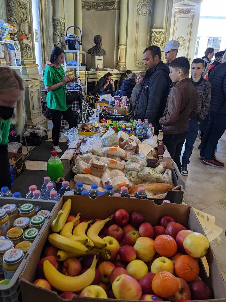 Ukrainian refugees receive food from volunteers in Hungary.