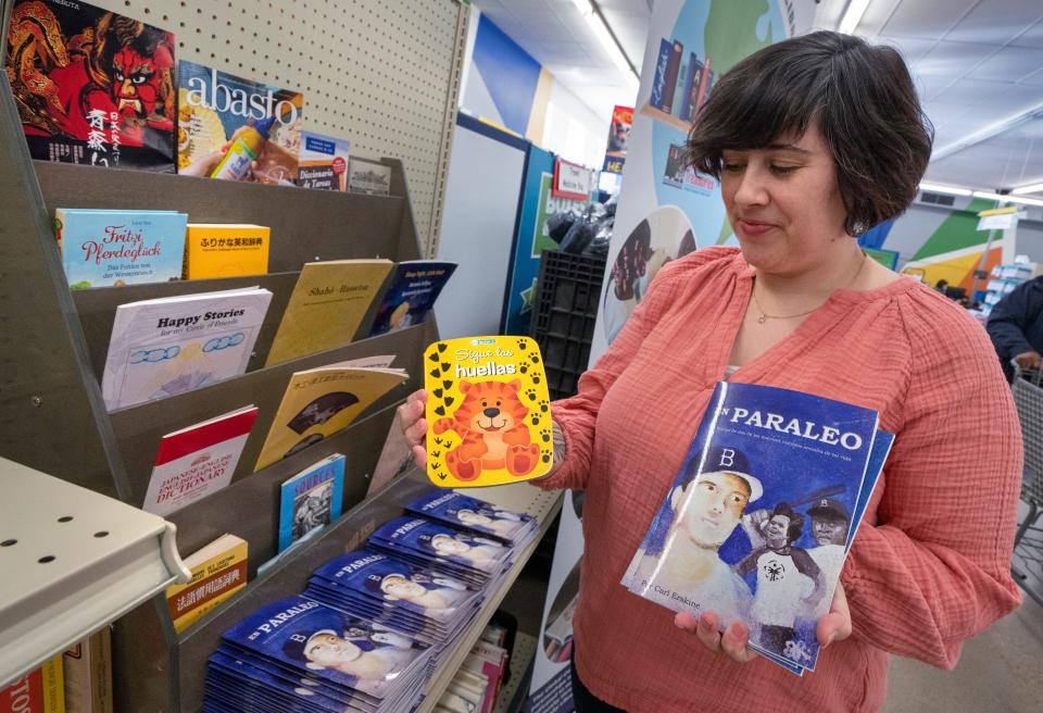 Hanna Yaeger-Busch, director of community engagement at Teachers’ Treasures, shows some of the foreign language books at the Global Language Library section at Teachers’ Treasures, Monday, Nov. 13, 2023. Marion County teachers of students in need can get free school supplies at the charity store which takes donations.