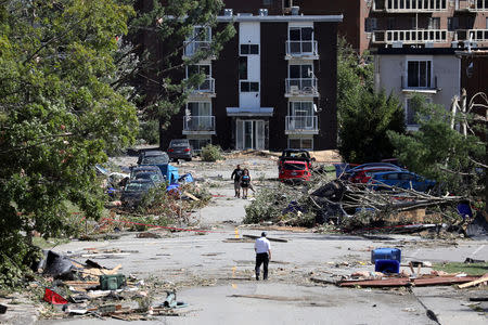 People look at the damage after a tornado hit the Mont-Bleu neighbourhood in Gatineau, Quebec, Canada, September 22, 2018. REUTERS/Chris Wattie