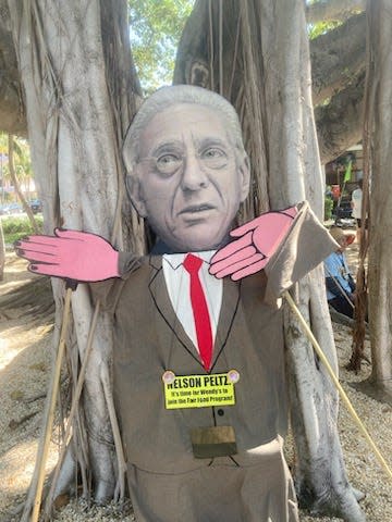 A caricature of financier Nelson Peltz was part of the farmworkers march Saturday in Palm Beach.