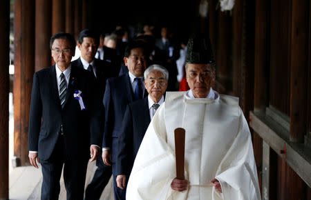 A group of lawmakers including Japan's ruling Liberal Democratic Party (LDP) lawmaker Hidehisa Otsuji are led by a Shinto priest as they visit Yasukuni Shrine in Tokyo, Japan April 21, 2017. REUTERS/Toru Hanai
