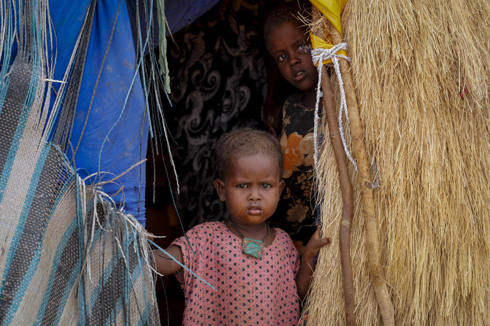 The daughter of a herder family stands in the doorway of their hut near Kuruti, in Garissa County, Kenya Wednesday, Oct. 27, 2021. As world leaders address a global climate summit in Britain, drought has descended yet again in northern Kenya, the latest in a series of climate shocks rippling through the Horn of Africa. (AP Photo/Brian Inganga)