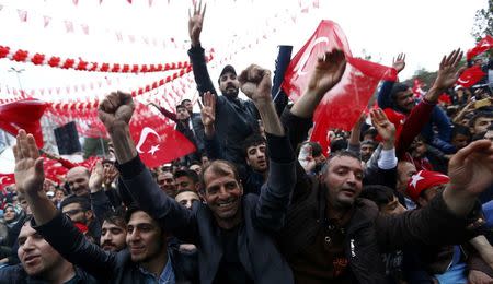 Supporters of Turkish President Tayyip Erdogan wave Turkey's national flags and shout slogans during a rally for the upcoming referendum in the Kurdish-dominated southeastern city of Diyarbakir, Turkey, April 1, 2017. REUTERS/Murad Sezer