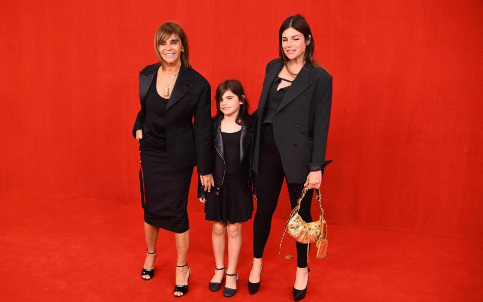 Former French Vogue editor Carine Roitfeld, her daughter Julia Restoin Roitfeld and granddaughter Romy at the Balenciaga show at Paris Fashion Week - AFP via Getty Images