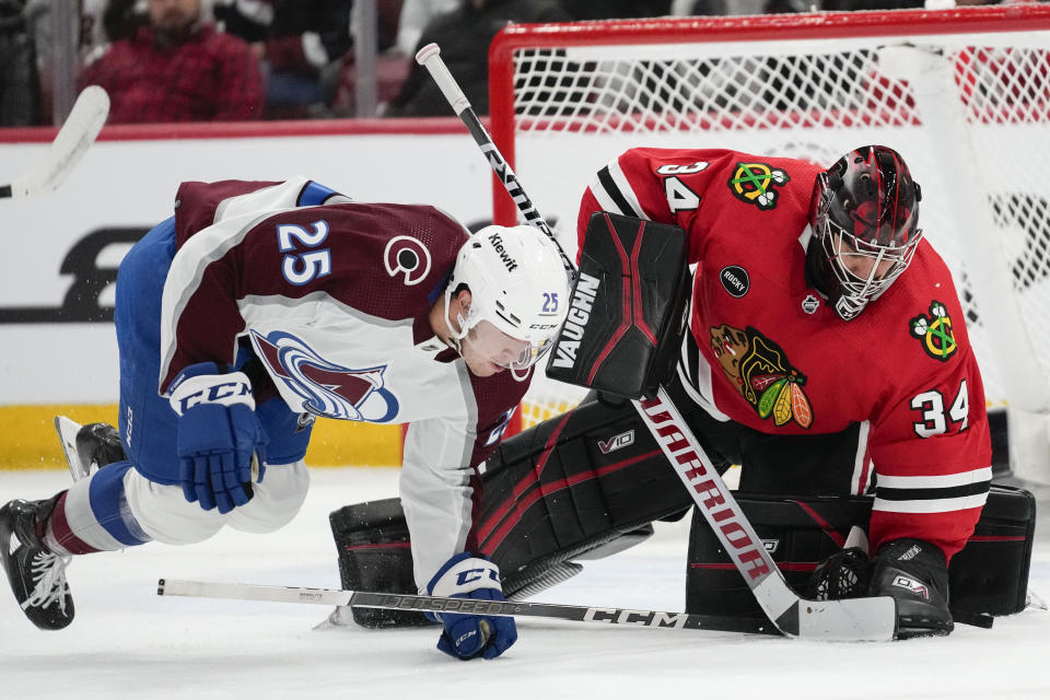 Chicago Blackhawks goaltender Petr Mrazek makes a save as Colorado Avalanche right wing Logan O'Connor dives in front during the third period of an NHL hockey game Tuesday, Dec. 19, 2023, in Chicago. The Blackhawks won 3-2. (AP Photo/Erin Hooley)