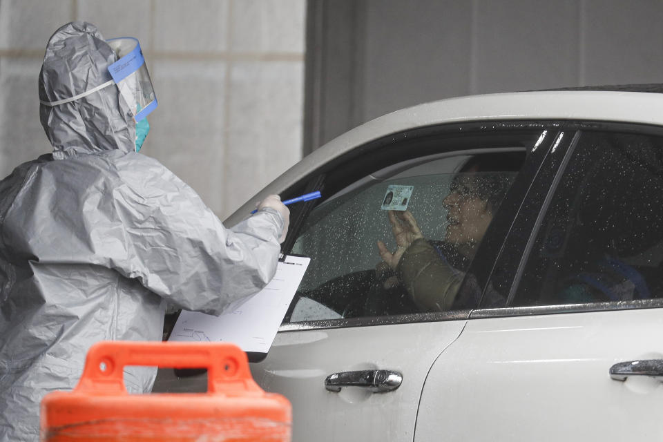 FILE- In this March 13, 2020 file photo, a patient arrives to be tested for the coronavirus at Glen Island Park in New Rochelle, N.Y. The first sustained coronavirus outbreak to be detected in the New York metropolitan area occurred in the suburb of New Rochelle. (AP Photo/John Minchillo)