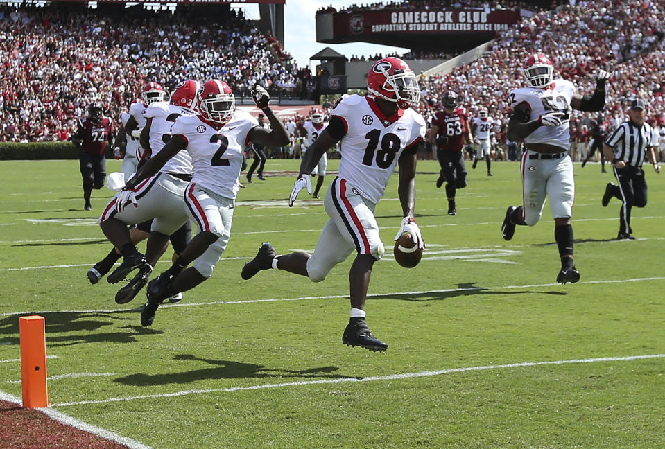 Georgia defensive back Deandre Baker returns an interception for a touchdown during the first quarter during an NCAA college football game against South Carolina, Saturday, Sept. 8, 2018, in Columbia, S.C. (Curtis Compton/Atlanta Journal-Constitution via AP)