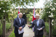 Britain's Prime Minister Boris Johnson, right, speaks with Australian Prime Minister Scott Morrison after their meeting, in the garden of 10 Downing Streeet, in London, Tuesday June 15, 2021. Britain and Australia have agreed on a free trade deal that will be released later Tuesday, Australian Trade Minister Dan Tehan said. (Dominic Lipinski/Pool Photo via AP)