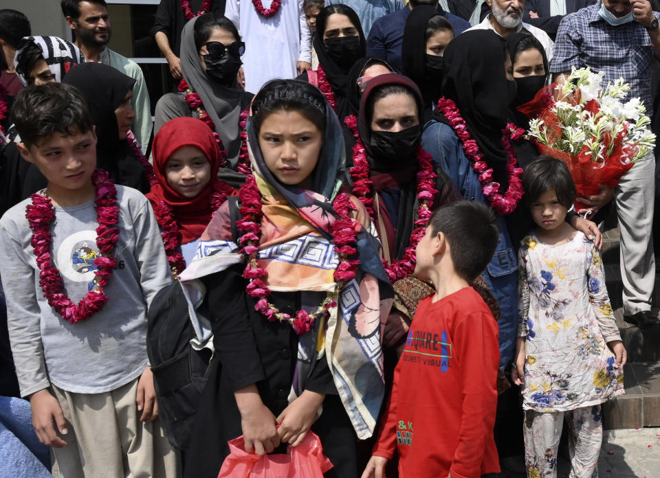 Members of Afghanistan's women soccer team and their families pose for a photograph after they were greeted by officials of the Pakistan Football Federation, in Lahore, Pakistan, Wednesday, Sept. 15, 2021. Officials and local media said Wednesday that an unspecified number of Afghan women players and their family members were allowed to enter in Pakistan after apparently fleeing their country for security reasons. (AP Photo/Waleed Ahmed)