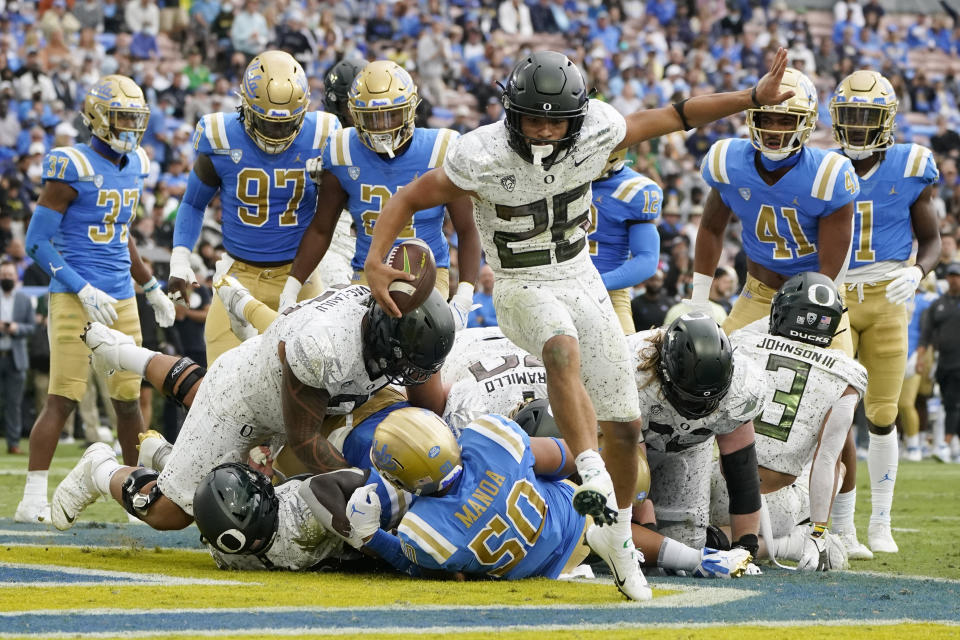 Oregon running back Travis Dye (26) scores a rushing touchdown during the second half of an NCAA college football game against UCLA, Saturday, Oct. 23, 2021, in Pasadena, Calif. (AP Photo/Marcio Jose Sanchez)