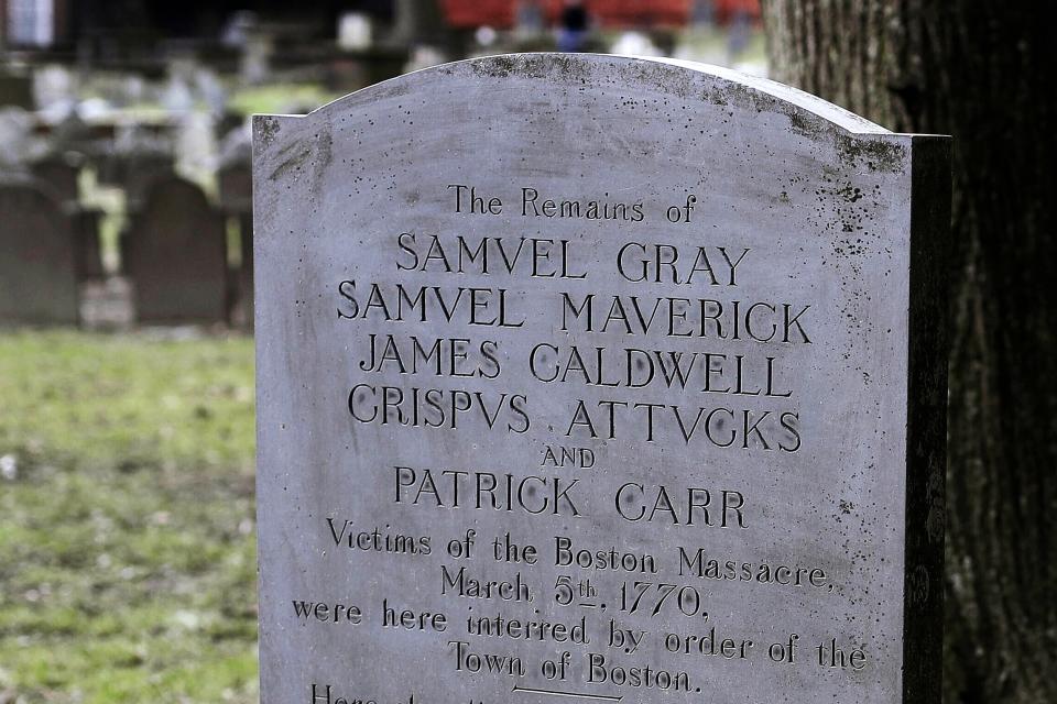 FILE - In this March 3, 2020, file photo, a gravestone marks the burial place at the Granary Burying Ground in Boston of those killed in the March 5, 1770, shooting by British soldiers known as the Boston Massacre. Crispus Attucks, a black man, was the first of those killed in the attack that helped touch off the American Revolution. (AP Photo/Steven Senne, File)