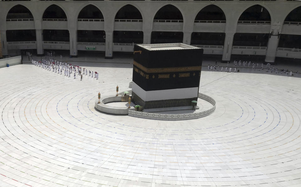 Muslim pilgrims line up as they leave after they circle the Kaaba, the cubic building at the Grand Mosque, as they keep social destination to protect themselves against Coronavirus a ahead of the Hajj pilgrimage in the Muslim holy city of Mecca, Saudi Arabia, Wednesday, July 29, 2020. During the first rites of hajj, Muslims circle the Kaaba counter-clockwise seven times while reciting supplications to God, then walk between two hills where Ibrahim's wife, Hagar, is believed to have run as she searched for water for her dying son before God brought forth a well that runs to this day. (AP Photo)