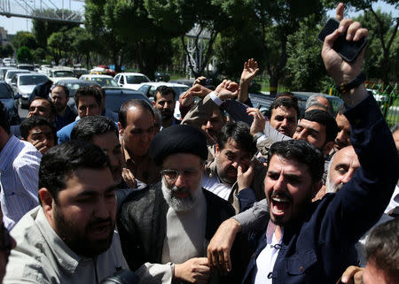 Iranian presidential candidate Ebrahim Raisi (C) arrives with crowds of supporters to cast his vote during the presidential election in Tehran, Iran, May 19, 2017. TIMA via REUTERS