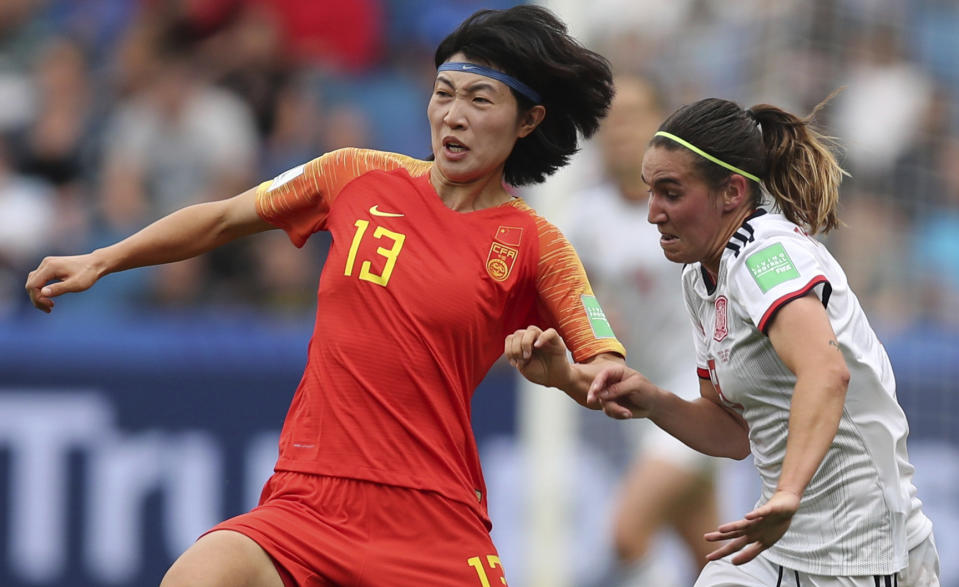 China's Wang Yan, left, vies for the ball against Spain's Mariona Caldentey during the Women's World Cup Group B soccer match between China and Spain at the Stade Oceane in Le Havre, France, Monday, June 17, 2019. (AP Photo/Francisco Seco)