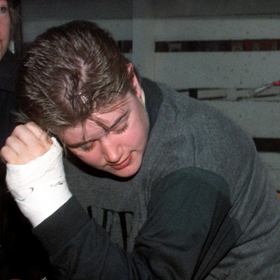 Beverley Allitt, with a bandaged hand, in a police van in 1993.