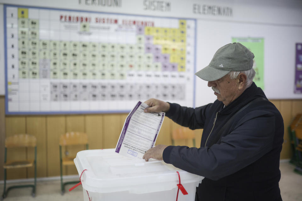 Bosnian man casts his vote at a poling station in Sarajevo, Bosnia, Sunday, Oct. 2, 2022. Polls opened Sunday in Bosnia for a general election that is unlikely to bring any structural change despite palpable disappointment in the small, ethnically divided Balkan country with the long-established cast of sectarian political leaders. (AP Photo/Armin Durgut)