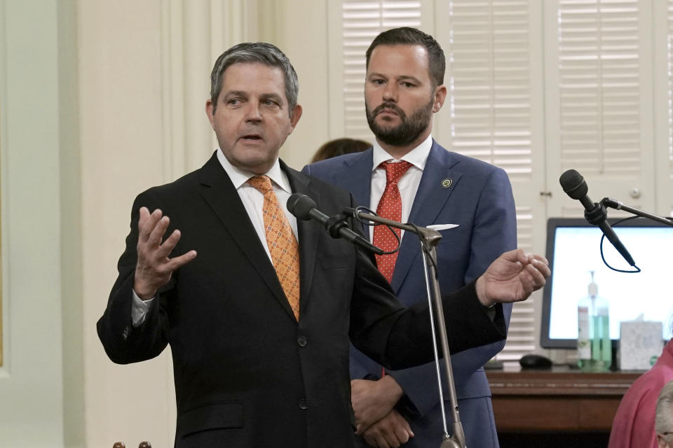 Assemblyman Jim Wood, D-Santa Rosa, left, calls on lawmakers to approve a measure carried by Assemblyman Matt Haney, D-San Francisco, right, to allow Los Angeles, Oakland and San Francisco, to set up places where opioid users could legally inject drugs in supervised settings, during the Assembly session in Sacramento, Calif., on Thursday, June 30, 2022. The Assembly approved the measure and sent it to back to the Senate for final consideration. (AP Photo/Rich Pedroncelli)