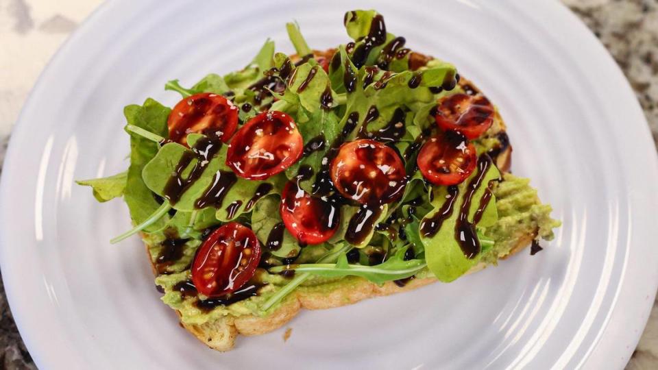 Sliced avocado on sourdough bread with arugla, cherry tomato olive oil, balsamic glaze and lemon pepper from Bubbles & Tea Coffeehouse in Nipomo.