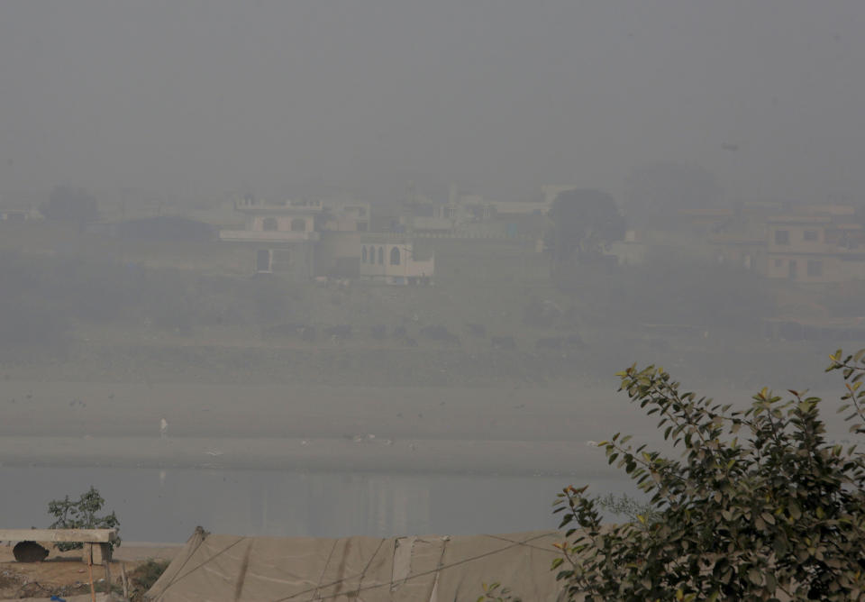 Heavy smog envelops the Ravi river and nearby areas of Lahore, Pakistan, Wednesday, Nov. 11, 2020. People in Pakistan’s cultural capital of Lahore were at risk of respiratory diseases and eye-related problems Wednesday after the air quality deteriorated to hazardous levels due to a quilt of smog over the city, prompting doctors to urge people to stay at home. (AP Photo/K.M. Chaudary)