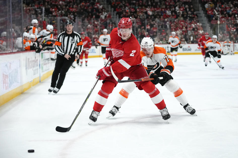 Detroit Red Wings defenseman Olli Maatta (2) and Philadelphia Flyers right wing Owen Tippett (74) chase the puck in the second period of an NHL hockey game Saturday, Jan. 21, 2023, in Detroit. (AP Photo/Paul Sancya)