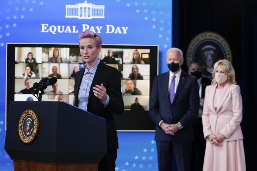 Megan Rapinoe with President Joe Biden and first lady Jill Biden at an event to mark Equal Pay Day. Washington, March 24, 2021. - Credit: AP/Evan Vucci