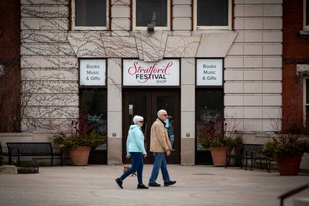 The Stratford Festival, which has been holding annual theatre productions in Stratford, Ont., since 1953, will put it’s entire 2020 season on hold amidst the COVID-19 pandemic.  See man and woman walking in front of Stratford Festival shop.