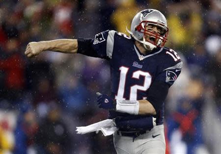 New England Patriots quarterback Tom Brady (12) reacts after a touchdown against the Indianapolis Colts in the first half during the 2013 AFC divisional playoff football game at Gillette Stadium. Mark L. Baer-USA TODAY Sports