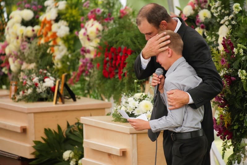 A child reacts during the funeral service of Dawna Ray Langford, 43, and her sons Trevor, Rogan, who were killed by unknown assailants, to be buried at the cemetery in La Mora,