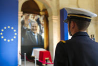 A military officer stands guard in front of the coffin of late French President Jacques Chirac, Sunday, Sept. 29, 2019 at the Invalides monument in Paris. Jacques Chirac will lie in state Sunday during a public ceremony at the Invalides monument, where France honors its heroes. A memorial service and private funeral are planned for Monday. (AP Photo/Kamil Zihnioglu)