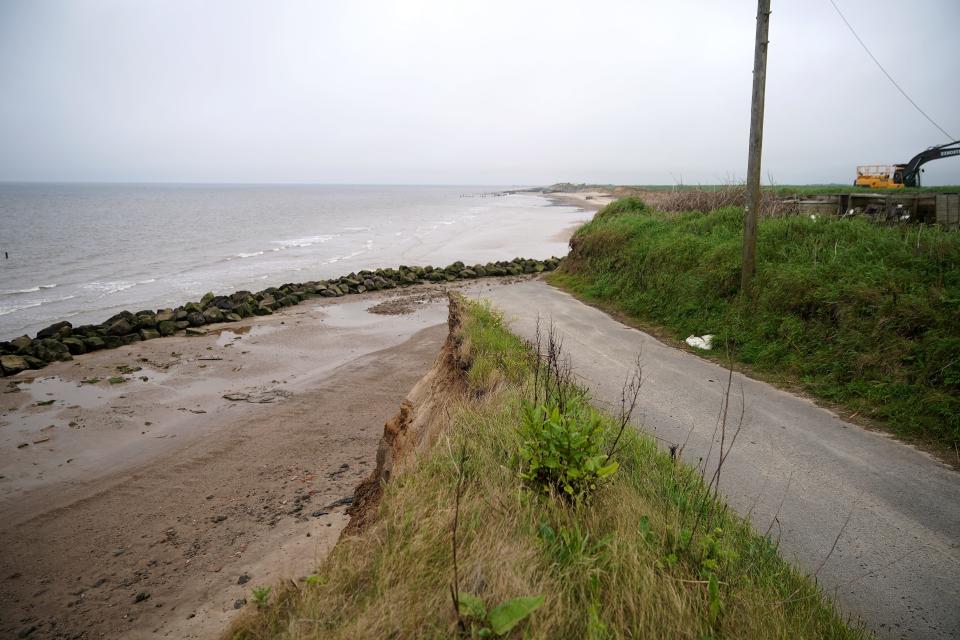 The end of a tarmac road shows the devastation caused by coastal erosion of the cliff face in the village of Happisburgh on June 4, 2018 in Great Yarmouth, England. The sea defences, which were built in the late 1950s at Happisburgh, north Norfolk have been failing over recent years with erosion of the sandy cliffs causing many buildings to be lost to the sea.