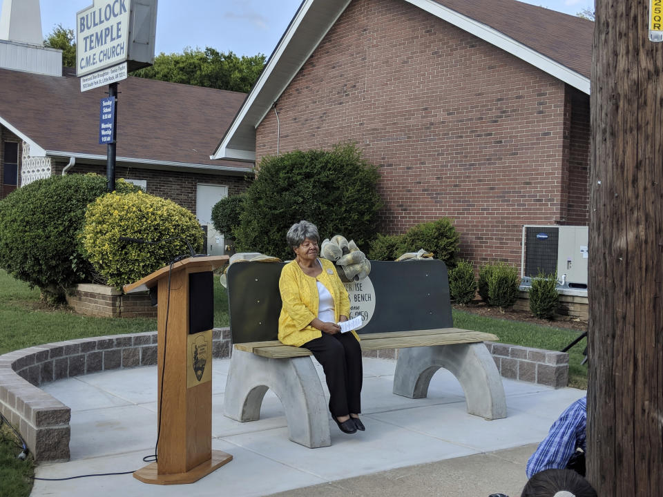 Elizabeth Eckford, one of the nine black students who first integrated Little Rock's Central High School in 1957, sits on a reconstructed commemorative bench on Tuesday, Sept. 4, 2018, 61 years to the day after she escaped to the bench from a crowd of white protesters who blocked her from entering the school in Little Rock, Ark. Current Central high students led the bench construction effort as part of the Central High Civil Rights Memory Project. (AP Photo/Hannah Grabenstein)