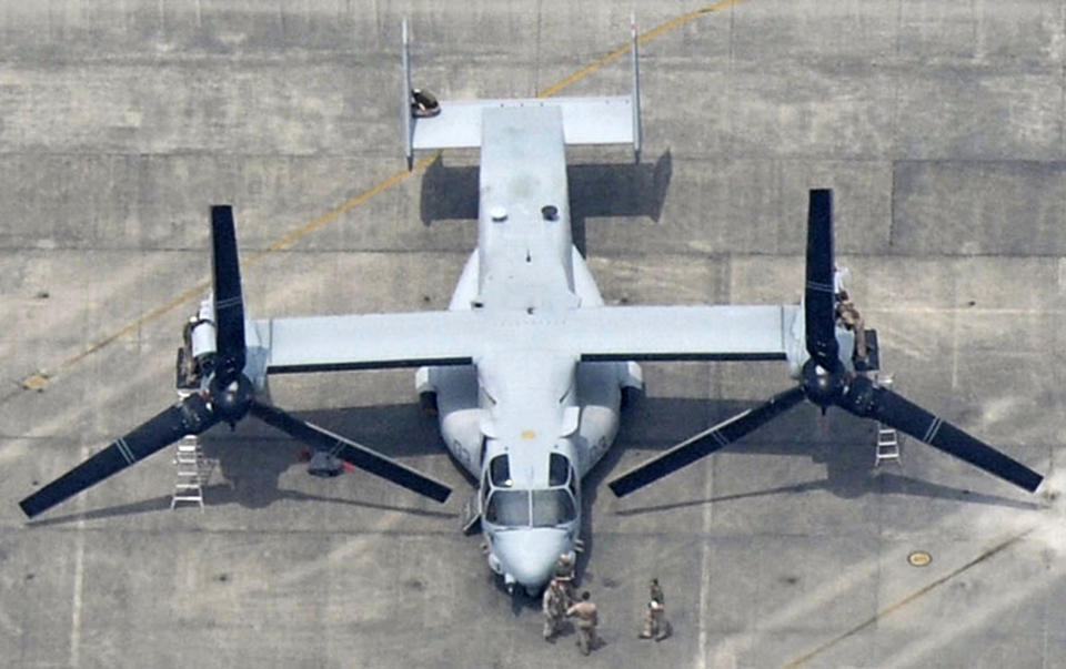 Ground crew members fit out a MV-22 Osprey at U.S. Marine Corps Air Station Iwakuni in Iwakuni, Yamaguchi Prefecture, western Japan, Monday, July 23, 2012. A shipload of the U.S. military's latest transport aircraft arrived in Japan on Monday amid protests over safety issues that have aggravated longstanding grassroots concern over the presence of American bases in the country. (AP Photo/Kyodo News) JAPAN OUT, MANDATORY CREDIT, NO LICENSING IN CHINA, HONG KONG, JAPAN, SOUTH KOREA AND FRANCE