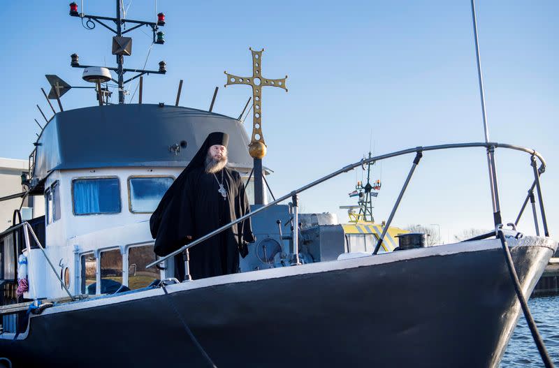 Father Abbot Abibon poses on the front deck of a mobile Georgian Orthodox monastery in Vlissingen